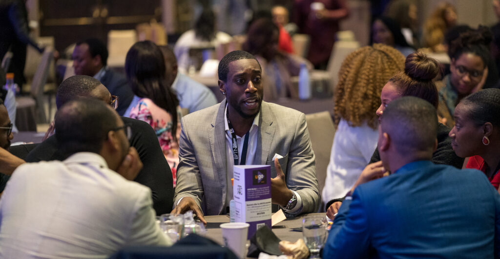 Senior level black professionals in tech talking at a table at BFUTR event