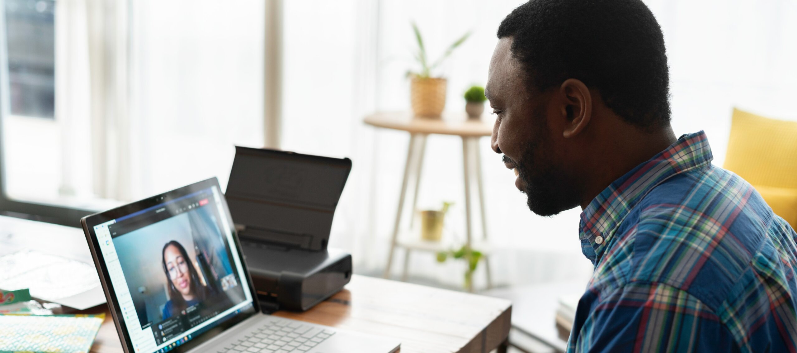 Black man on video call with woman coworker
