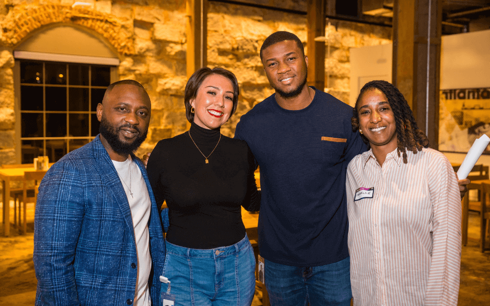 Two men and two women smiling together for group photo showcasing diversity in tech
