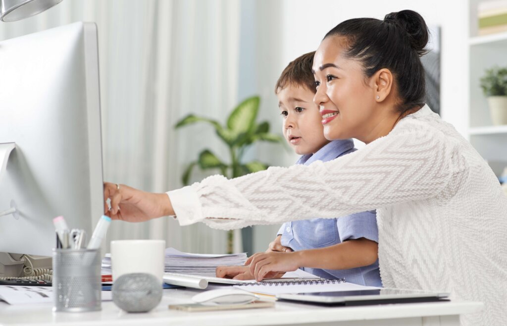 Mother and son looking at computer together
