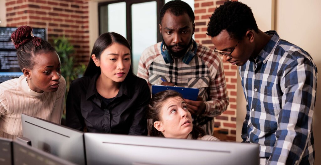 Diverse team collaborating on computer project