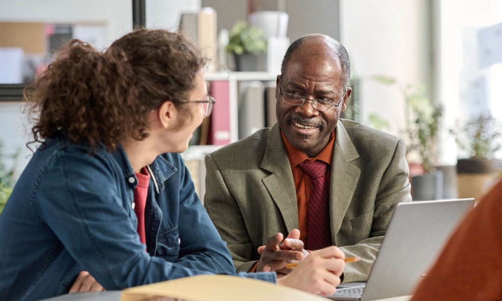 Older Black man mentoring a younger man