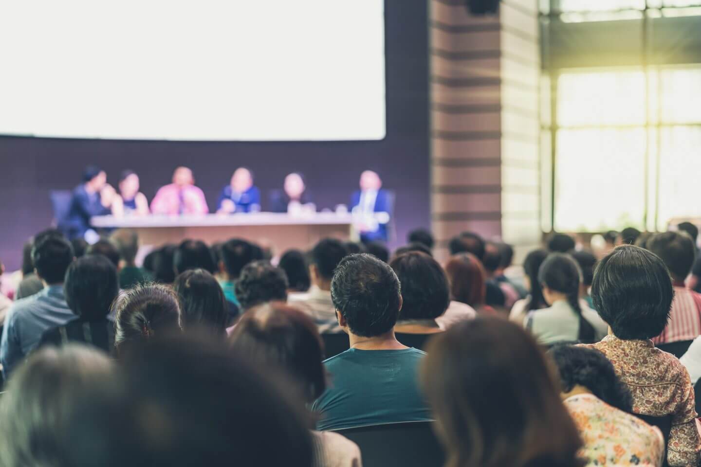 rear-view-of-audience-in-the-conference-hall-or-seminar-meeting-which-have-speakers-e1700247718953.jpg