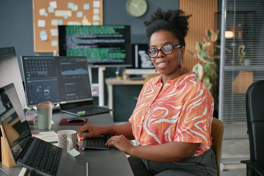 Portrait of Young Adult Black Woman Working at Computer in Modern Office